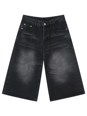 Wide-leg denim culotte shorts in washed black with buttoned fly and front pockets.