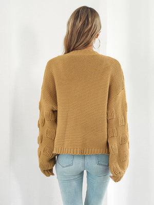 Camel knit cardigan with textured bubble sleeves and ribbed cuffs.