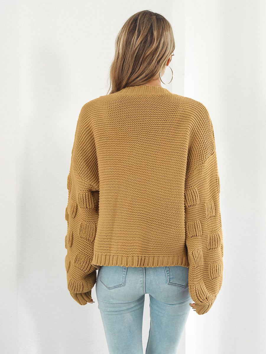 Camel knit cardigan with textured bubble sleeves and ribbed cuffs.