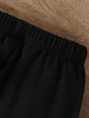 Black toddler outfit detail showing elastic waistband on pants