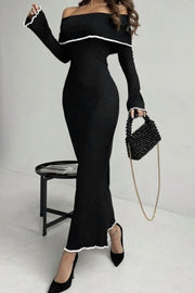 Black off-shoulder maxi dress with ruffled trim and long sleeves.