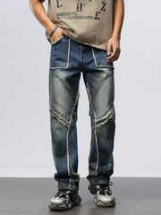 Men's wide leg jeans in blue denim with frayed hem details and patchwork design.