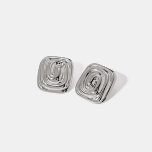 Silver sculpted swirl square earrings with a contemporary, chic design.