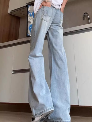 Men's light blue distressed full-length flare jeans with a cotton blend fabric.