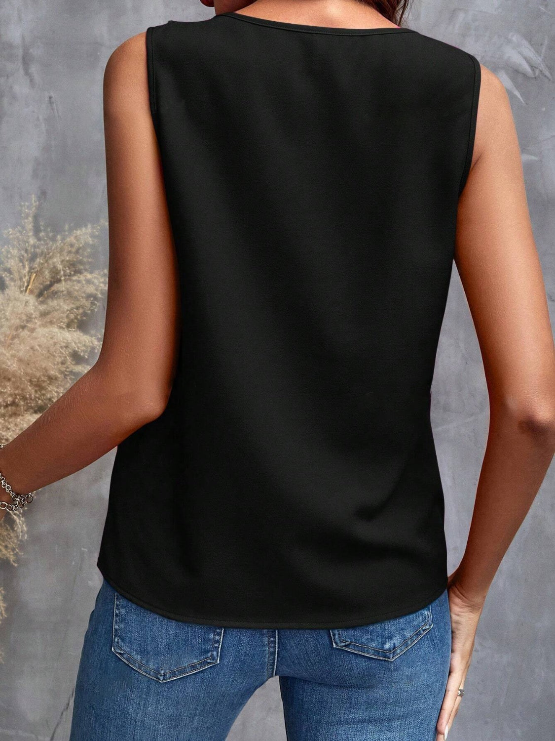 Black sleeveless blouse with cascading ruffles, casual style