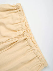 Pastel Yellow maternity pants with drawstring waist and wide legs.