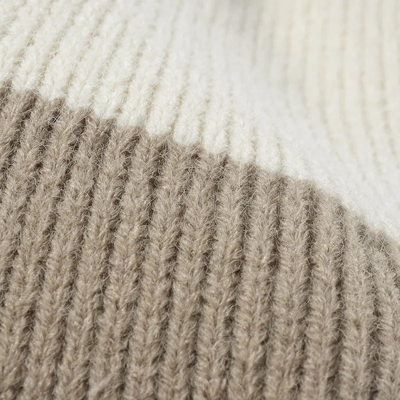 Colorblock knit beanie in cream and khaki with ribbed texture detail.