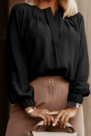 Black pleated yoke blouse with button detail and elastic cuffs.
