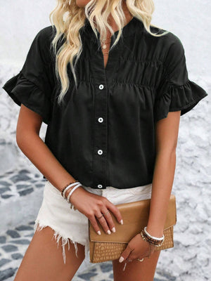 Black button-up blouse with gathered yoke and ruffle sleeves.