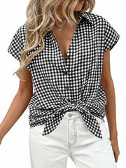 Black gingham print tied button-down shirt with short sleeves and a deep V-neck.