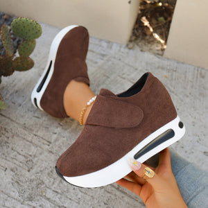 Brown chunky platform sneakers with air cushion and hook-and-loop closure.