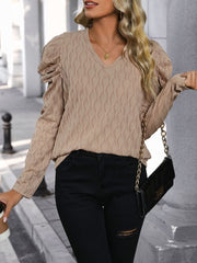 Mocha knit sweater with wave stitching, V-neck, and puff sleeves.