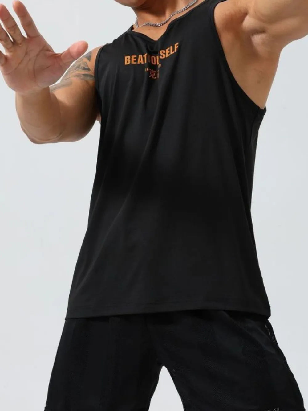 Black performance tank top with orange graphic inscription "BEAT O SELF" and Chinese characters.