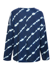 Indigo tie-dye long sleeve Henley top in peacock blue with diagonal white streaks.