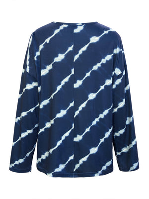 Indigo tie-dye long sleeve Henley top in peacock blue with diagonal white streaks.