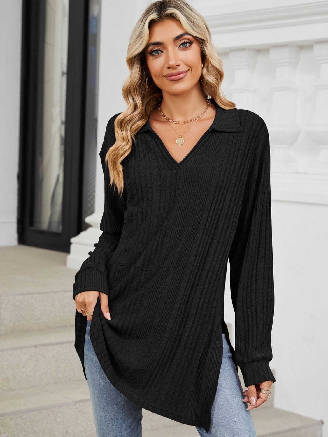 Black ribbed knit collared tunic top with long sleeves and slit hem detail.
