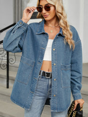 Oversized denim trucker jacket in medium blue with button front and chest pockets.