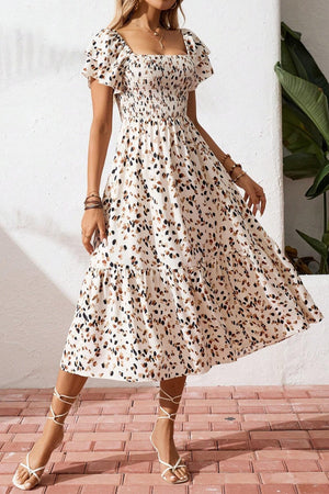 Tiered ruffle sleeve midi dress with abstract print, smocked bodice, and square neckline.