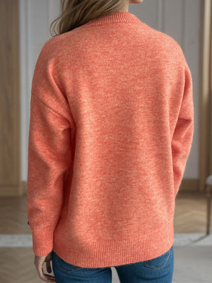 Orange textured knit crew neck pullover sweater with ribbed cuffs and hem.