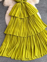 Yellow pleated midi dress with tiered skirt and matching belt.