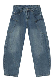 Medium wash denim balloon trousers with unique paneling and a relaxed fit.