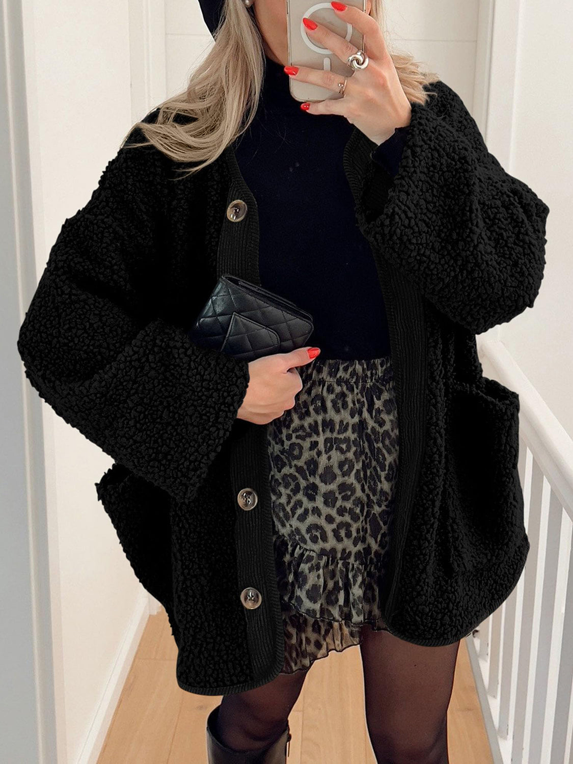 Black teddy-texture button-up jacket with corduroy trim and pockets.