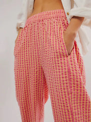 Pink and yellow gingham check wide-leg pants with pockets and elastic waist.