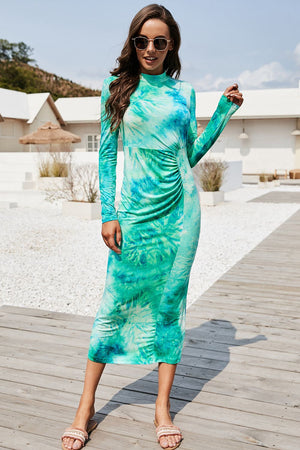Tie-dye ruched midi dress with mock neck in turquoise and green, long sleeves, ruched side detail.
