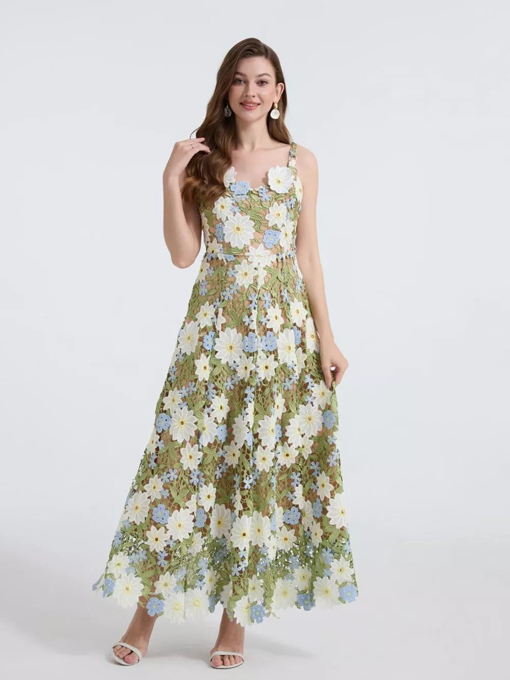 Embroidered floral maxi dress with appliqué in green and white with blue accents.