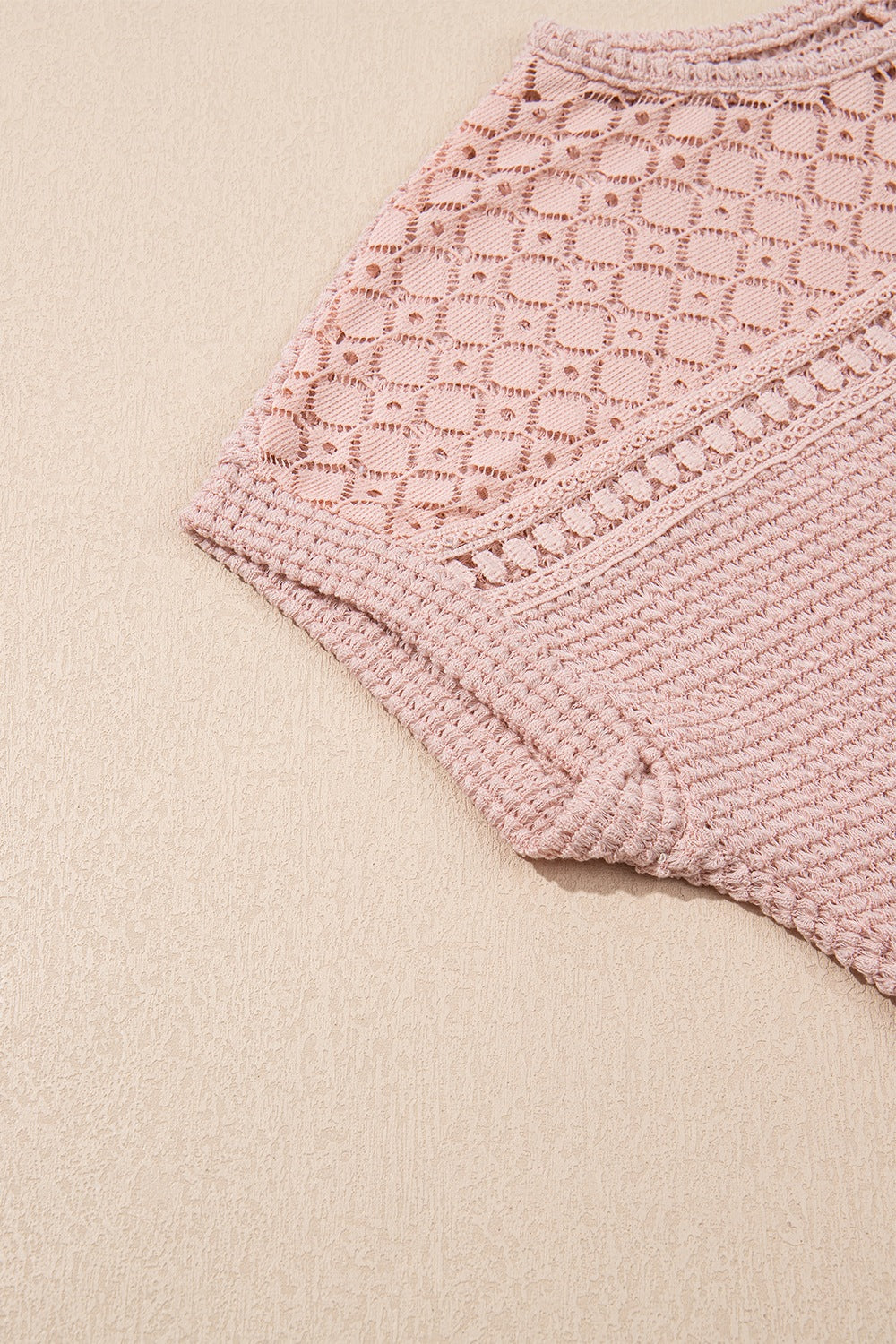 Dusty pink waffle knit top with intricate lace yoke detail and textured sleeves.