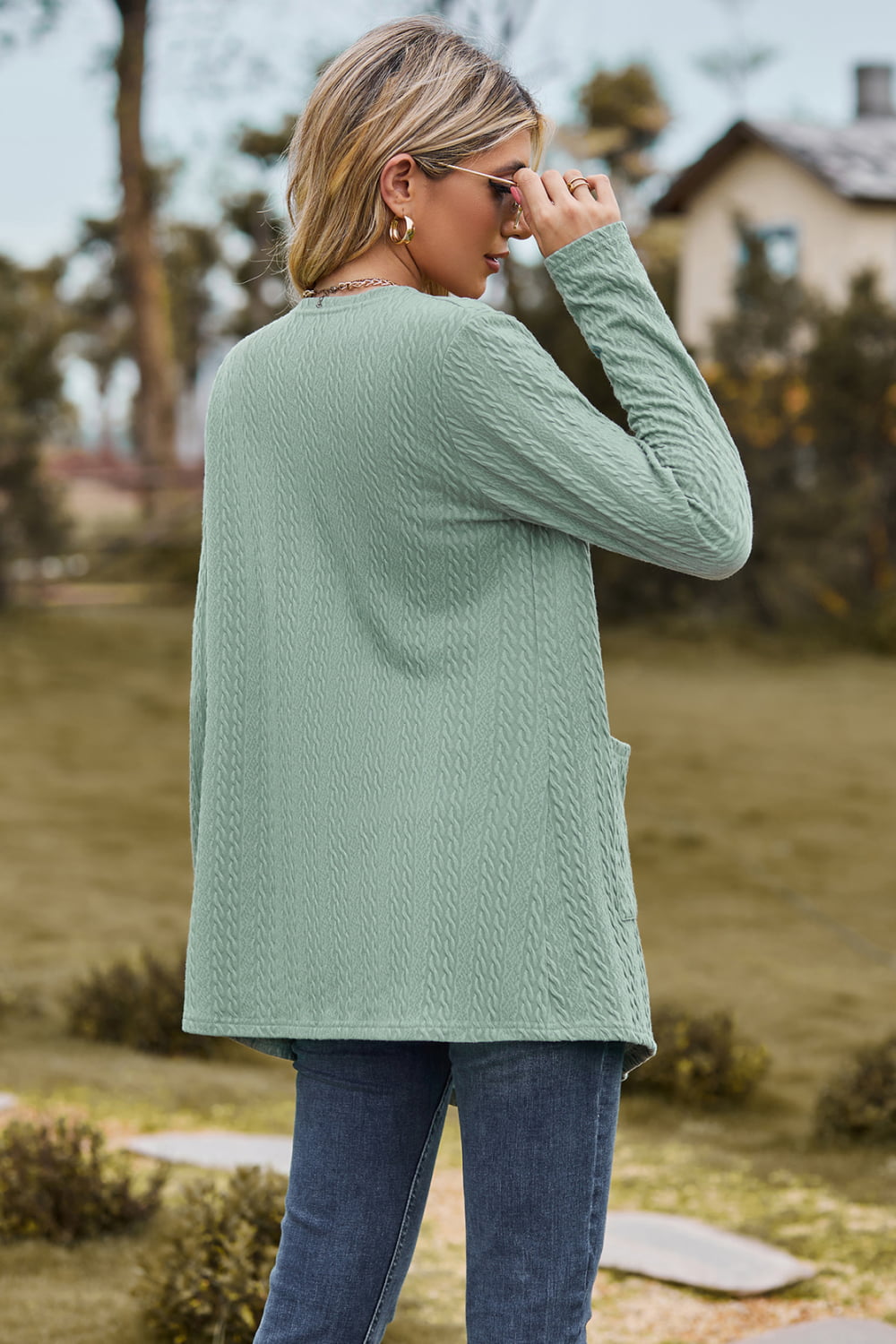 Sage textured open-front cardigan with pockets and long sleeves.