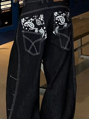 Relaxed fit dark wash denim cargo jeans with contrast stitching and paisley back pockets.