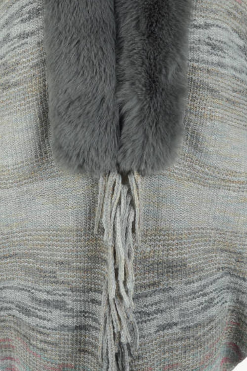 Textured knit cape in Dark Gray with faux fur collar and fringe detail.