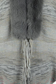 Textured knit cape in Dark Gray with faux fur collar and fringe detail.