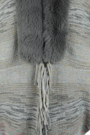 Textured knit cape in Dark Gray with faux fur collar and fringe detail.