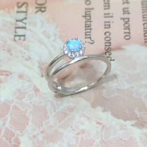 Silver ring with iridescent opal and diamond halo on double band