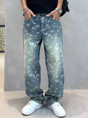 Loose-fit denim jeans with all-over bird print in light wash blue cotton.