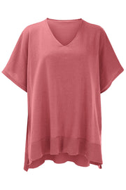 Relaxed V-neck knit poncho top in dusty pink with short sleeves and ribbed hem.