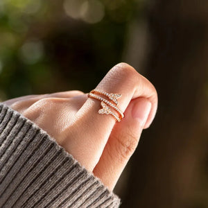 Gold bypass ring with two diamond-accented butterflies on a 18K gold-plated band.