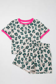 Leopard print pajama set with pink trim, featuring a short sleeve top and elastic waist shorts.