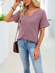 Ribbed knit short sleeve t-shirt in dusty blue with V-neck and decorative buttons.