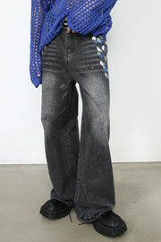 Painterly flare jeans in dark wash denim with artistic paint splatters and a wide leg.