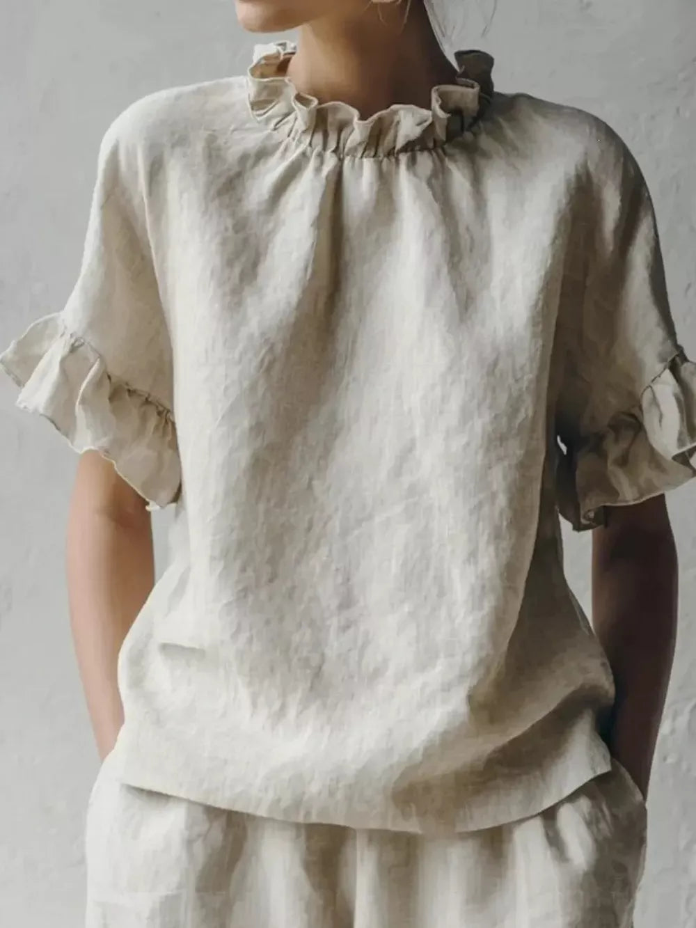 Apricot linen shirt with ruffled neckline and half sleeves.