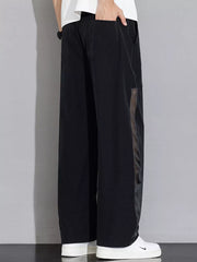 Black wide-leg sweatpants with mesh panel detail and drawstring waist.
