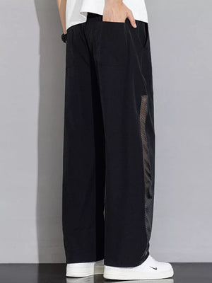 Black wide-leg sweatpants with mesh panel detail and drawstring waist.