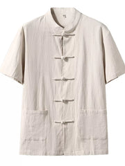 Khaki cotton short-sleeve shirt with mandarin collar and frog button closure, two front pockets.