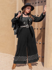 Black viscose palazzo jumpsuit with square neck and embroidered hem.