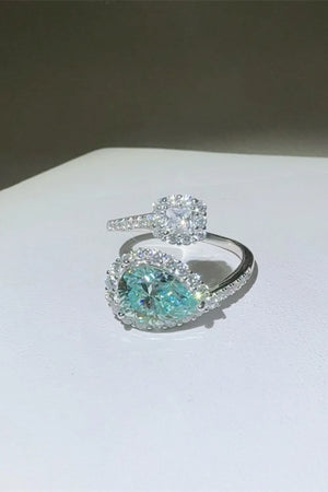 Turquoise pear-cut moissanite bypass ring with halo and square halo ring.