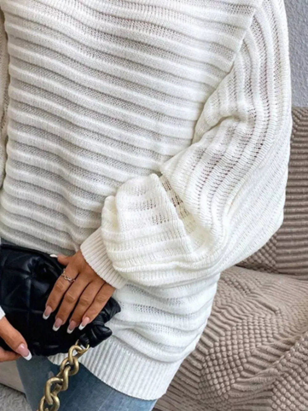 White ribbed knit sweater with balloon sleeves and a chic one-shoulder design.