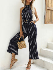Navy polka dot halter romper with belted waist and wide legs